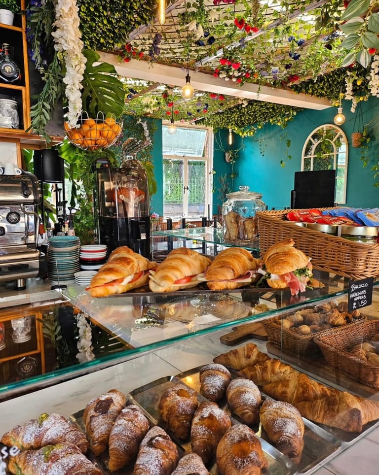 The flower-covered interior of Zuki's Caffetteria, a café on Queen Street, Exeter